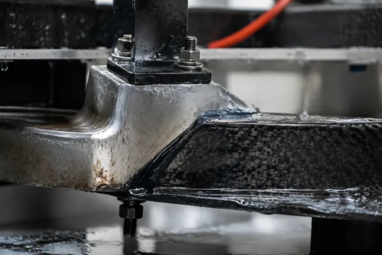 Bonding Adhesive 14 A realistic close-up of bonded parts in an industrial testing environment, showing durability under moisture, heat, vibration, and outdoor exposure.