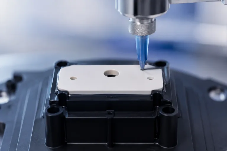 Ceramic Adhesive 5 A realistic close-up product photo showing ceramic-to-plastic adhesive bonding during assembly of a sensor or appliance component, with clean industrial surroundings and detailed materials.