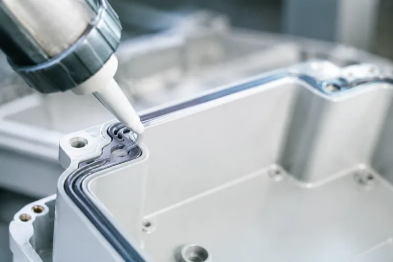 Sealing Adhesive 6 A professional close-up product photo showing sealing adhesive applied along an enclosure joint, emphasizing protection against water, dust, and air leakage in a clean industrial setting.