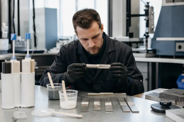 A professional lab scene showing evaluation of bonded samples for mechanical performance beyond simple lap shear.
