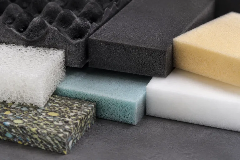 Foam Adhesive 13 Realistic industrial product photography showing several foam types prepared for adhesive selection and bonding tests in a clean technical setting.