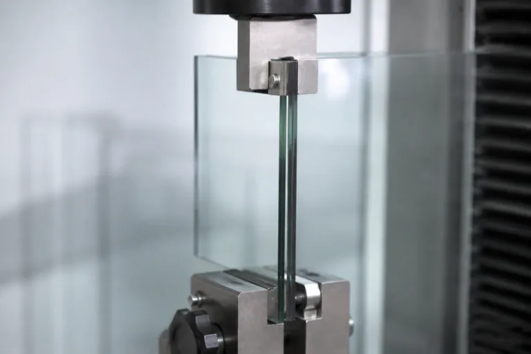 Glass Adhesive 15 A realistic close-up engineering test scene showing a bonded glass assembly under gentle shear or support testing, emphasizing adhesive strength while maintaining visual clarity and a professional product photography look.
