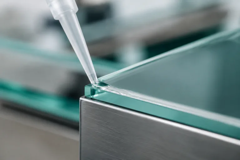Bonding Adhesive 5 Professional product photography showing transparent adhesive application for glass bonding, with a precise clean line in an industrial manufacturing context.