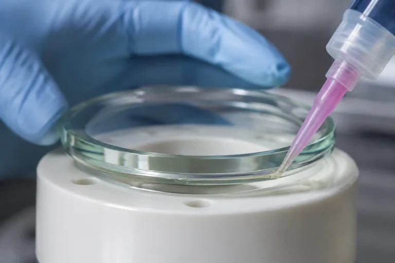 Glass Adhesive 6 A realistic close-up of precise adhesive bonding between glass and ceramic components in a professional manufacturing environment.
