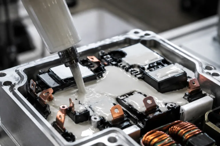 Insulation Adhesive 5 A realistic close-up industrial scene of insulating adhesive being applied inside a power module, highlighting electrical protection, durability, and precision manufacturing.