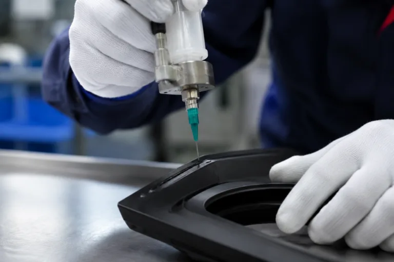 Rubber Adhesive 17 A realistic close-up view of industrial rubber adhesive application in a factory, showing precise dispensing onto rubber strips, gaskets, or flexible components during controlled assembly.