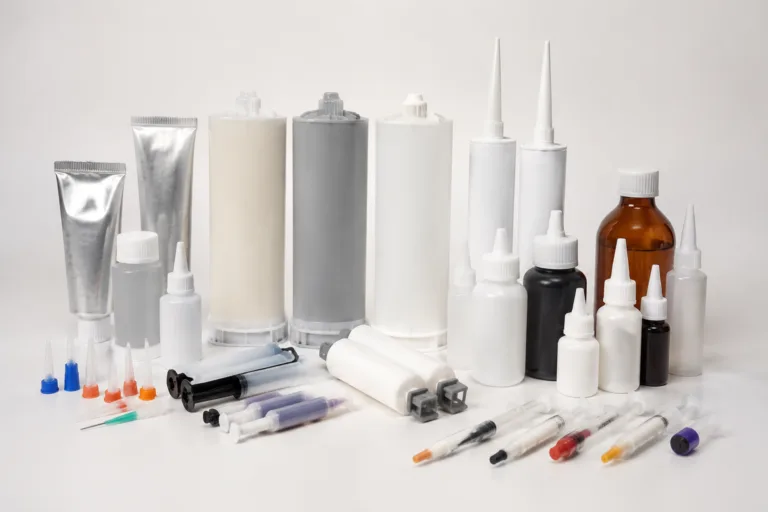 Become a ZDS Adhesive Distributor 2 Realistic industrial product photography showing a broad range of adhesive types arranged in a premium manufacturer presentation with a clean, organized layout.